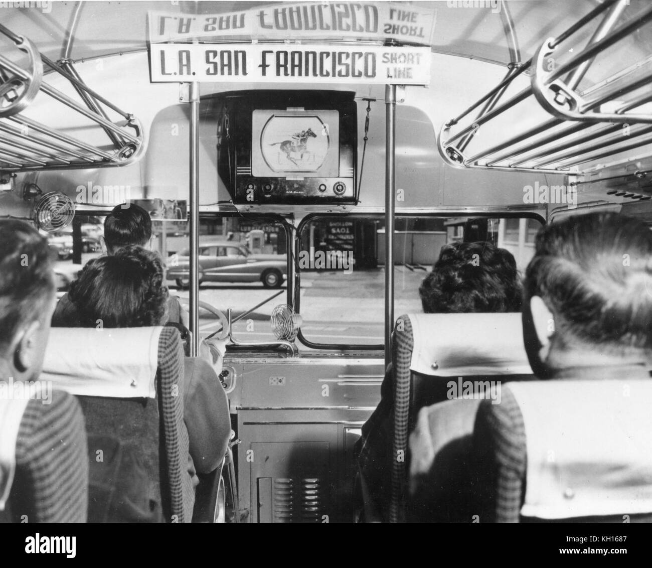 A television set is operated to entertain passengers on a bus making the Los Angeles to San Francisco run. The screen is positioned so the bus driver cannot see the set. August/1950. Stock Photo
