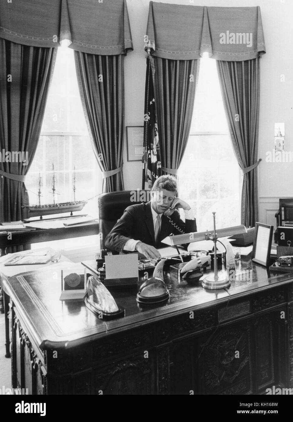 President John F. Kennedy at his desk in the Oval Office, Washington, DC, August 23, 1962. Photo by Abbie Rowe. Stock Photo