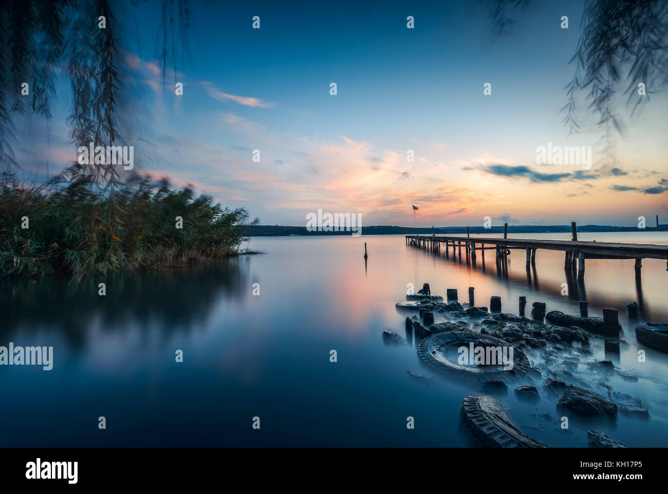 Small Dock and sunset at the lake Stock Photo - Alamy