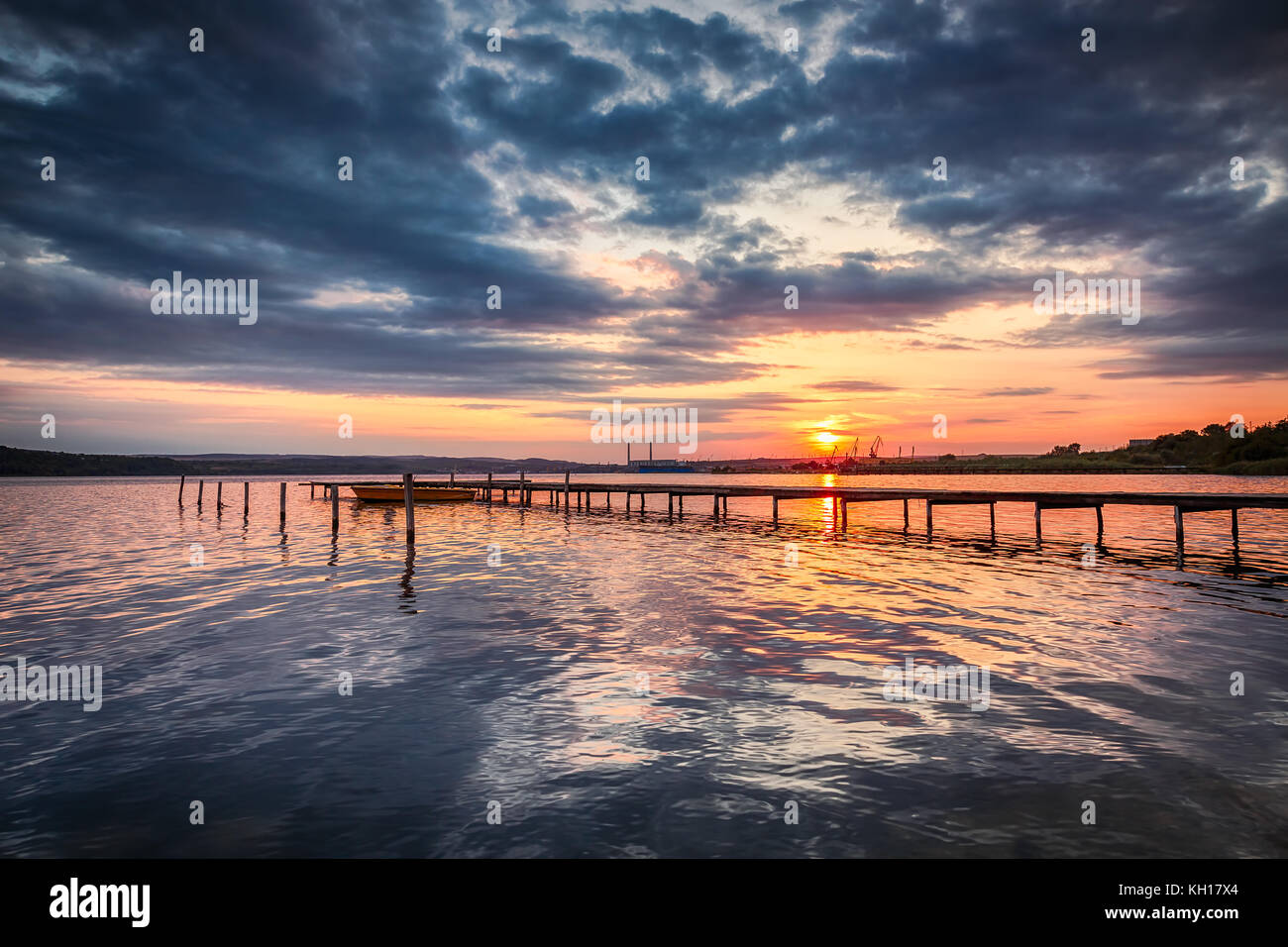 Small Dock and Boat at the lake, sunset shot Stock Photo - Alamy