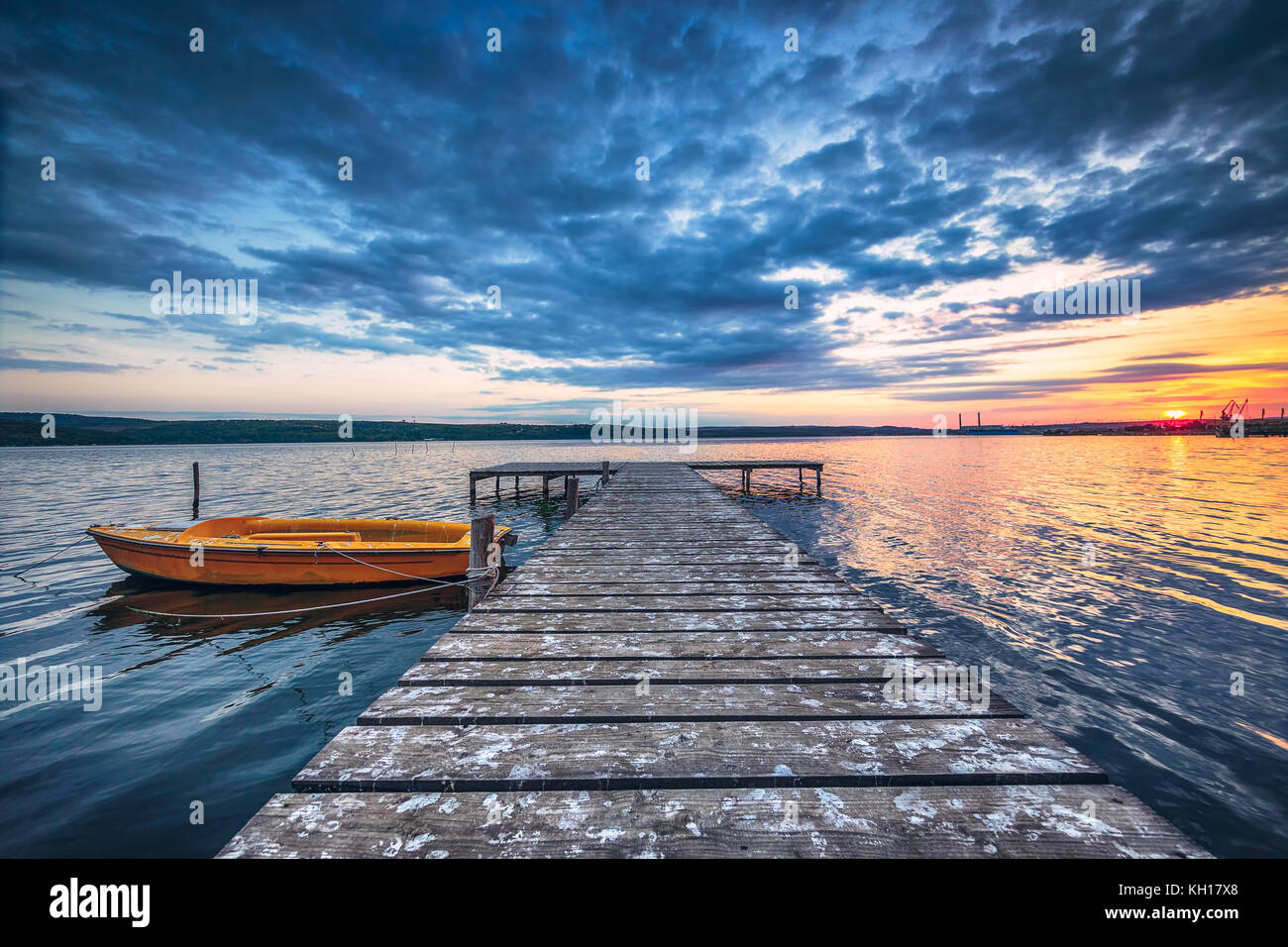 Small Dock and Boat at the lake, sunset shot Stock Photo - Alamy