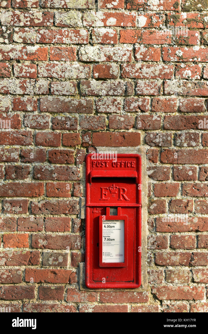 A traditional english Royal Mail or post office posting letter box set in to an old red brick wall on the Blickling estate in Norfolk. Stock Photo