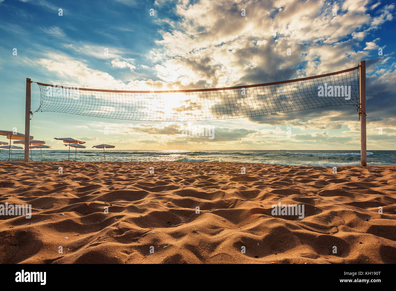 Volleyball net and sunrise on the beach Stock Photo