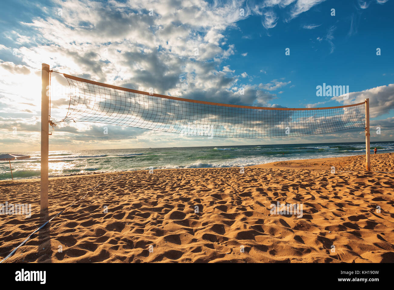 Volleyball net and sunrise on the beach Stock Photo