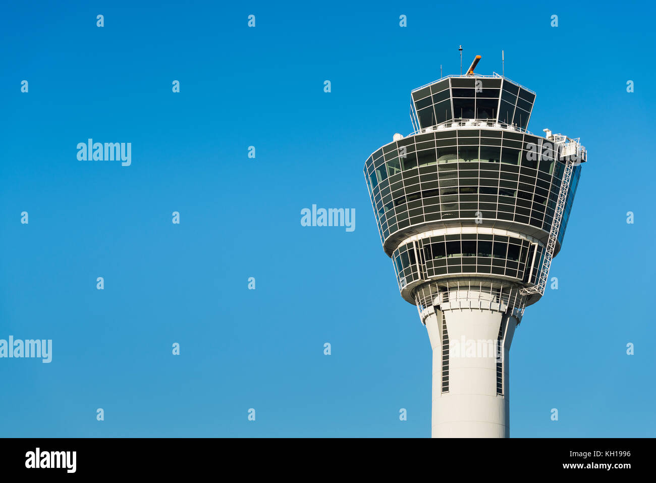 White air traffic control tower of Munich airport MUC in morning sun in front of blue cloudless sky, Bavaria, Germany Stock Photo