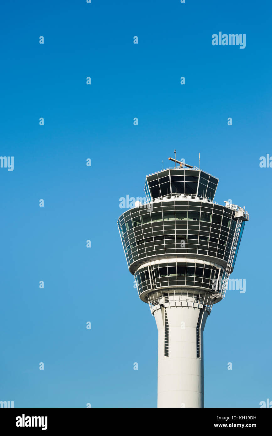 White air traffic control tower of Munich airport MUC in morning sun in front of blue cloudless sky, Bavaria, Germany Stock Photo