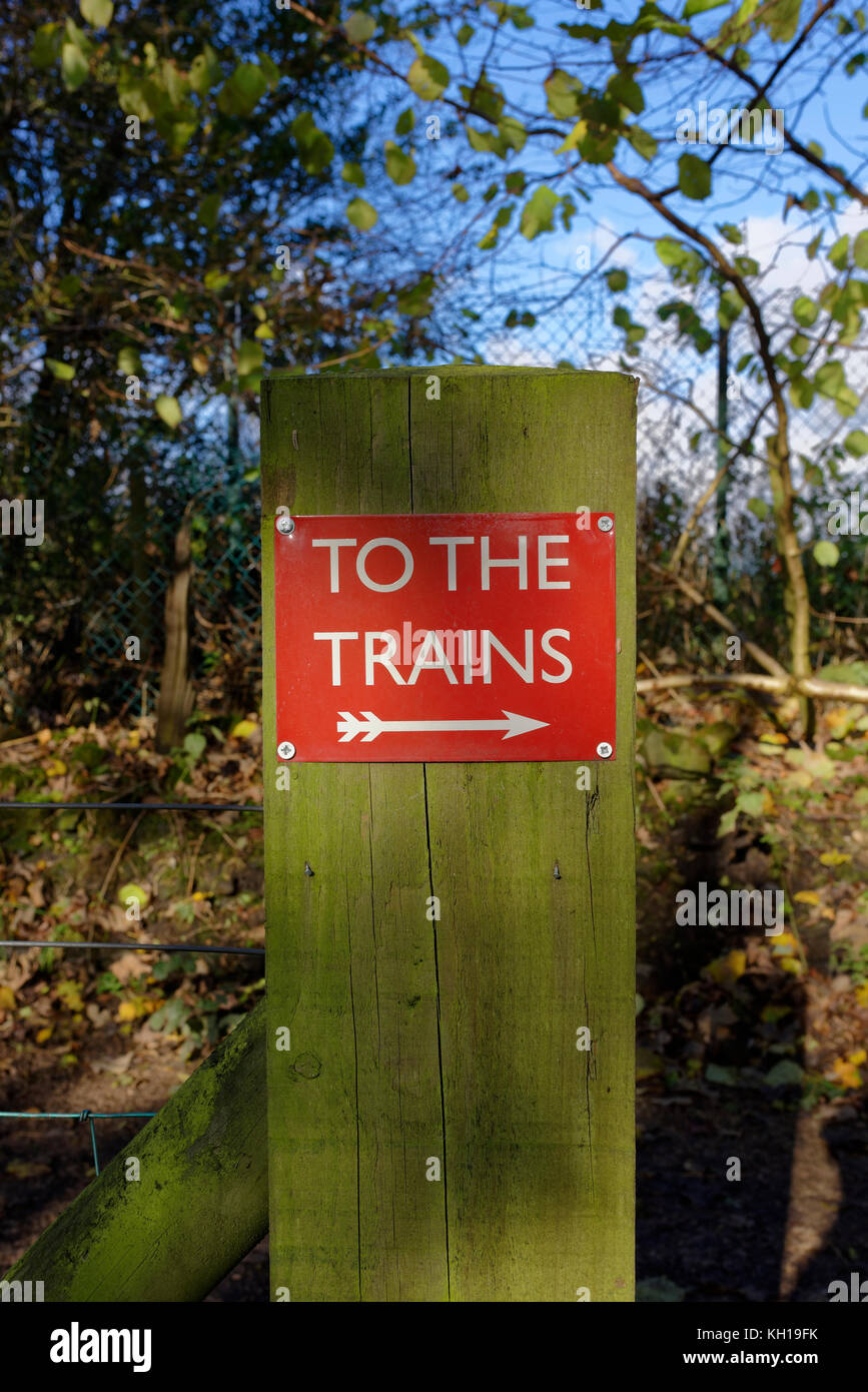 To the trains sign on algae covered wooden post in burrs country park bury lancashire uk Stock Photo