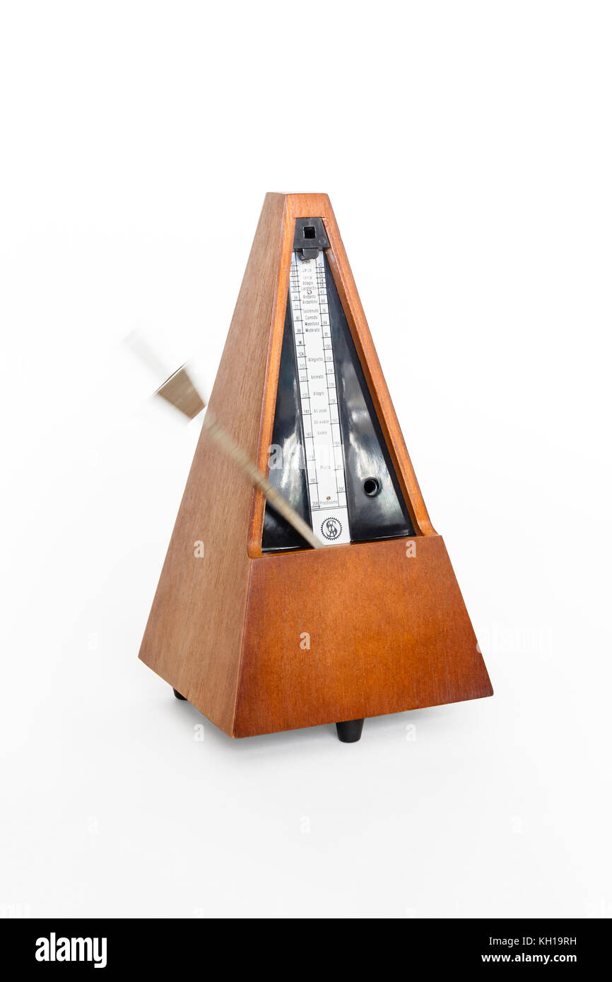 A traditional wooden clockwork Maelzel pyramid metronome against a white background, 1970s Stock Photo