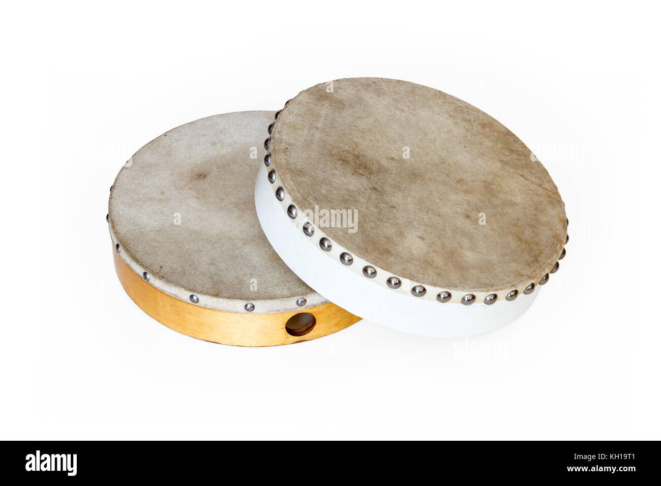 Two traditional tambour drums, one white one natural wood colour, against a white background Stock Photo