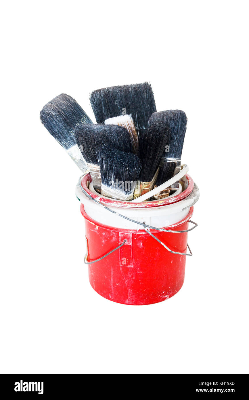 Household painting brushes in a stack of paint kettles against a white background Stock Photo