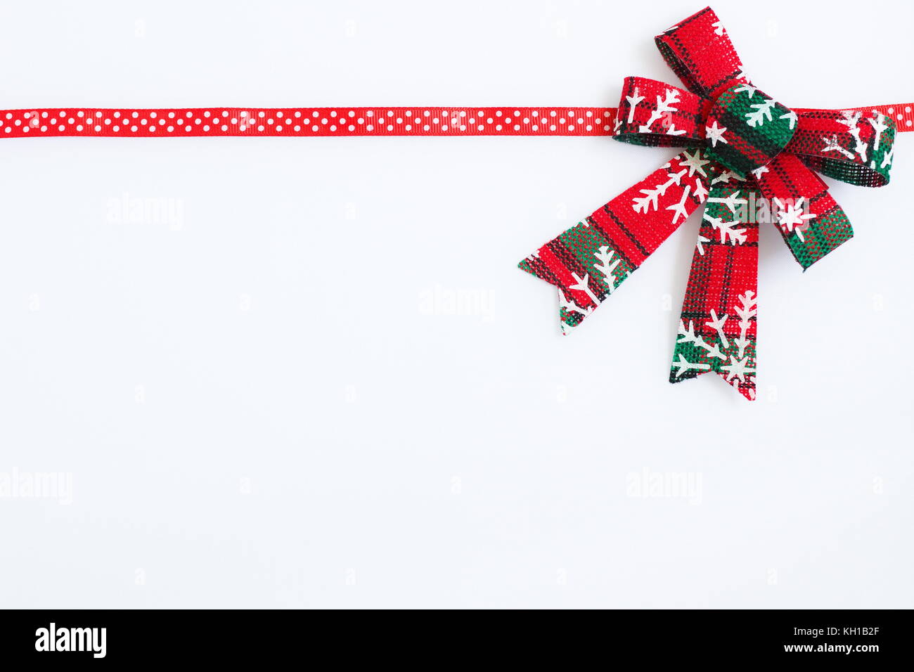 a red ribbon with christmas decoration on a white background Stock Photo