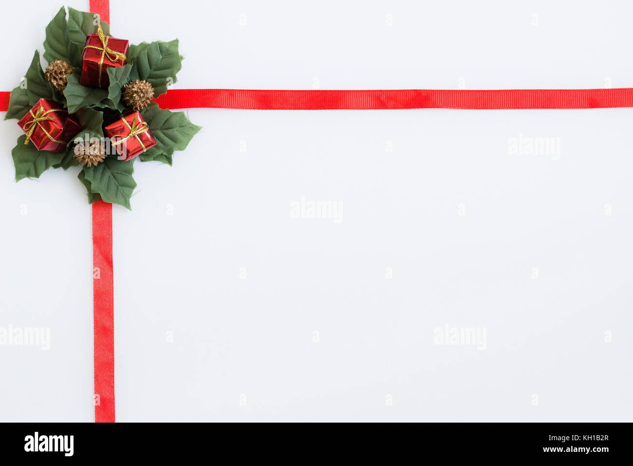 a red ribbon with christmas decoration on a white background Stock Photo
