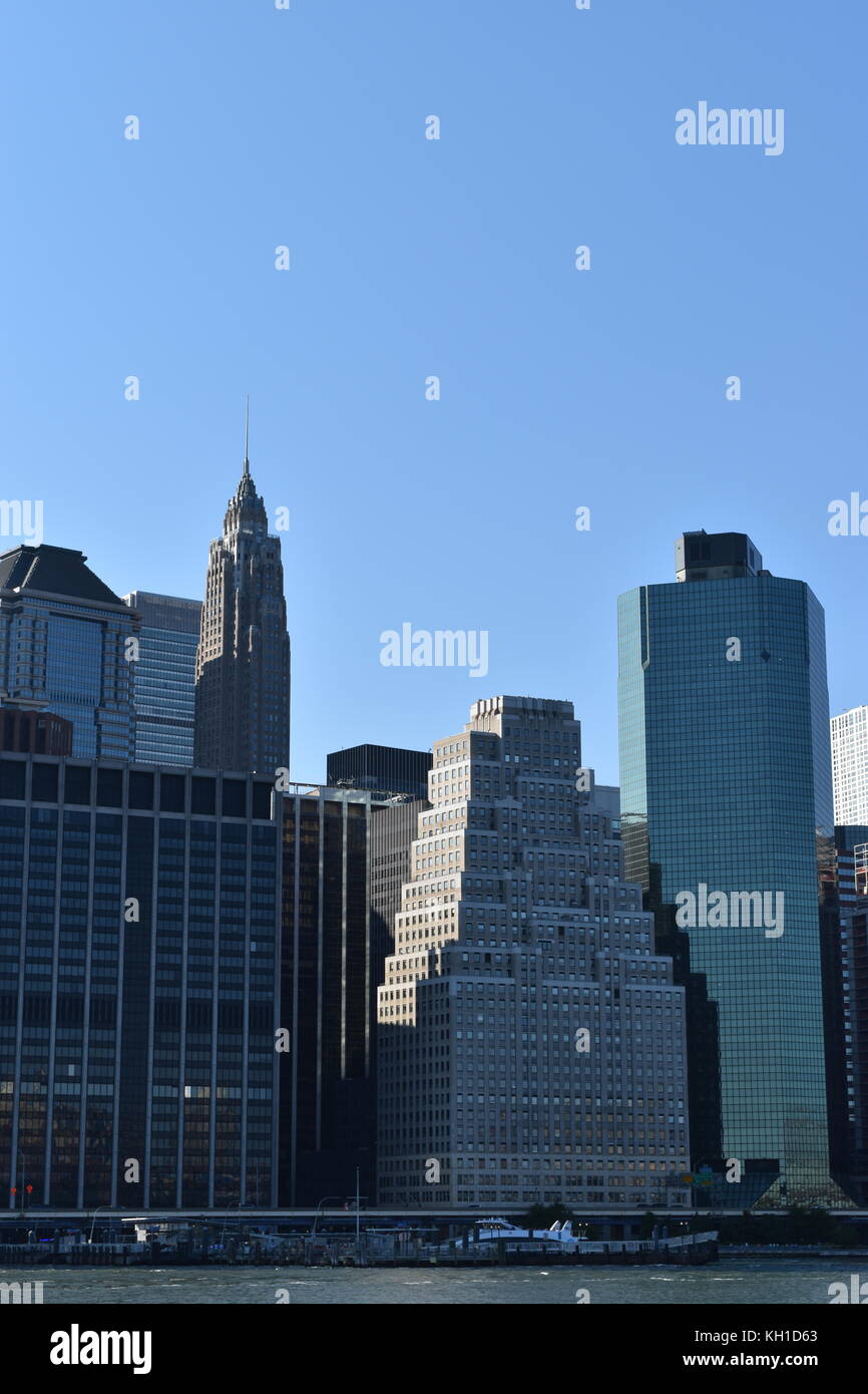 Offices and buildings at the end of Wall Street, with the 70 Pine Street Building in the background, Financial District, New York City. Stock Photo