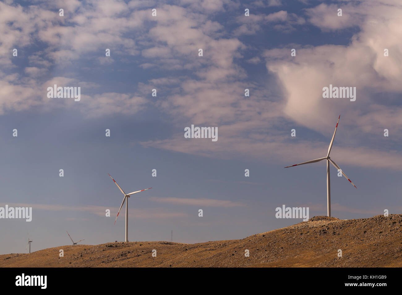 high hill landscape with wind turbines power energy for life Stock Photo