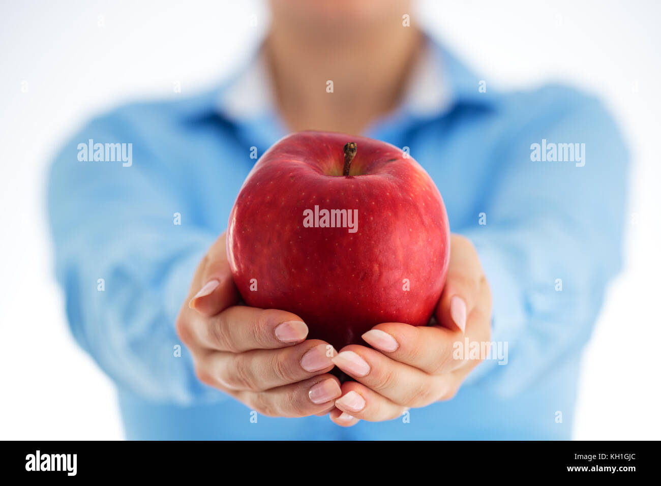 ulovlig overskud Overflødig Concept of healthy eating in the office. Business woman holding big red  apple in his hands, studio shot Stock Photo - Alamy