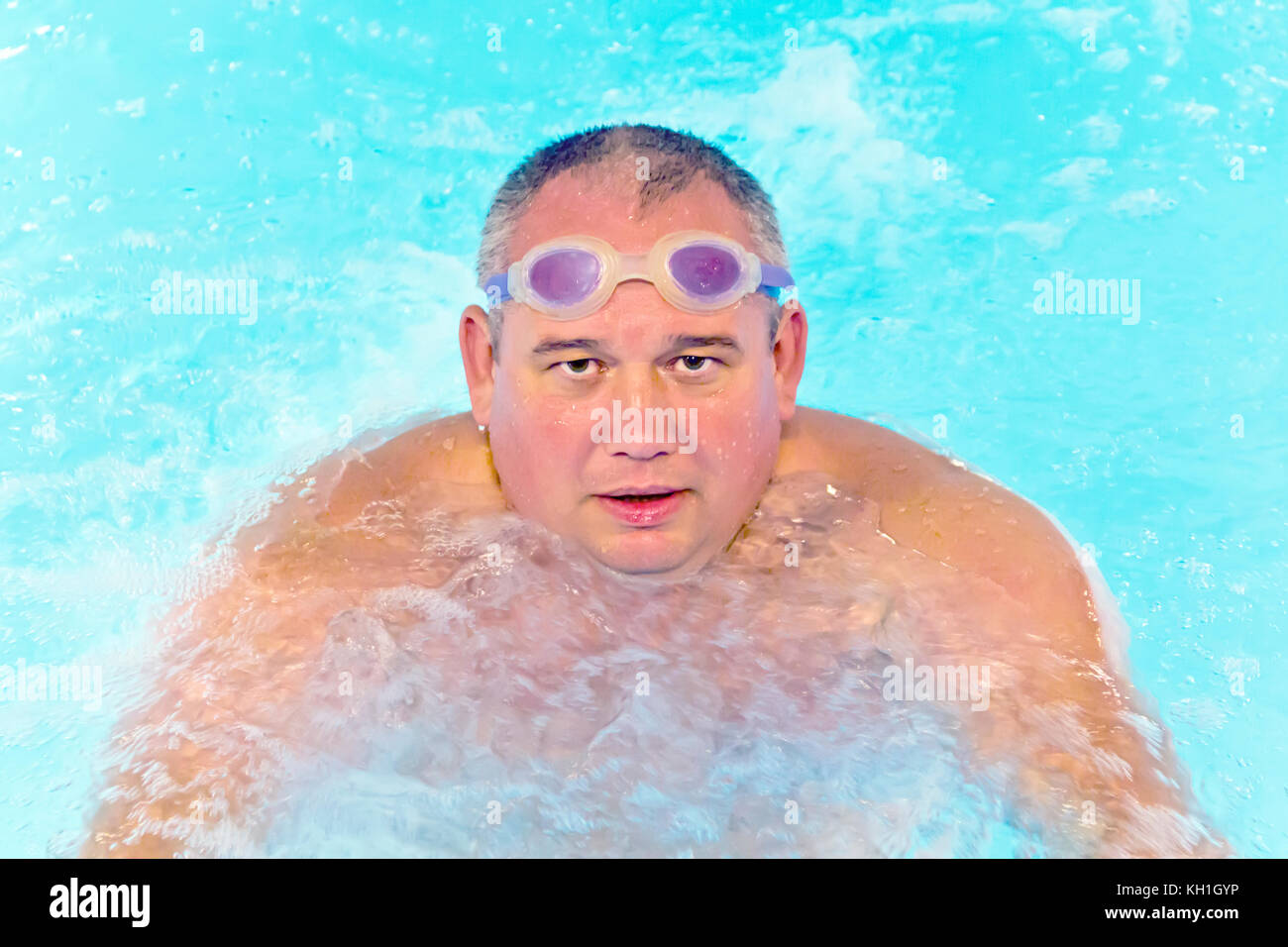 Portrait of big fat man in swimming pool water Stock Photo