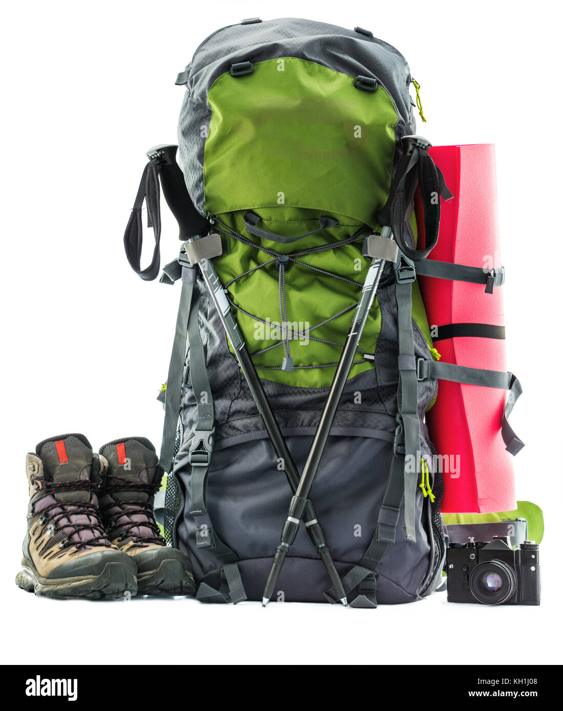 Large green touristic backpack and hiking equipment, rucksack, boots and slipping pad isolated on white Stock Photo