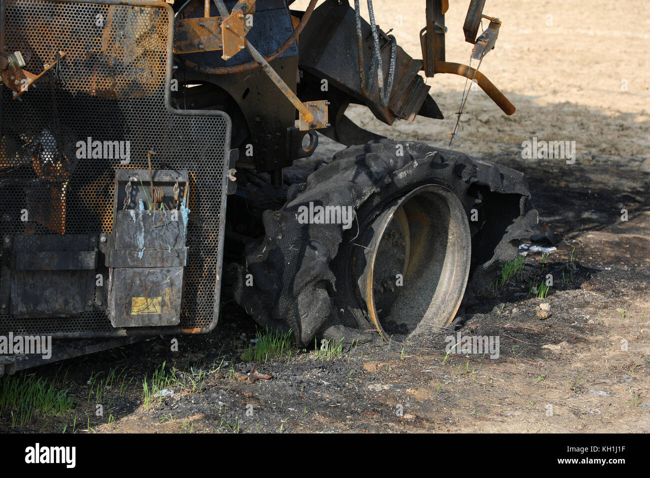 Closeup of combine harvester destroyed by fire Stock Photo
