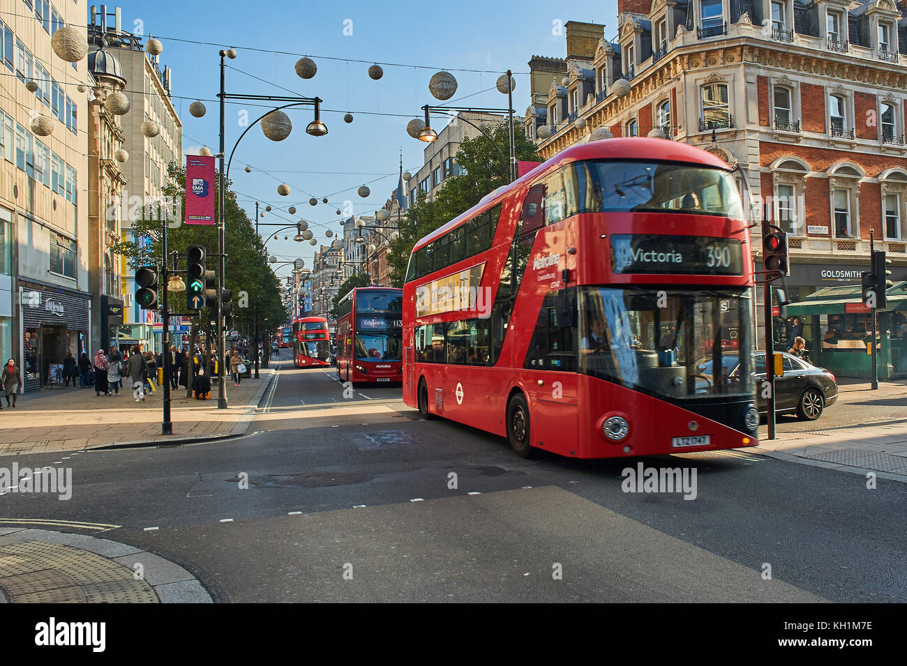 A red double decker bus in London's West End travels down Oxford Street. London buses are a great way to travel around the city. Stock Photo