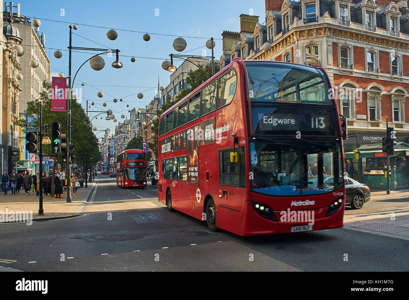 A red double decker bus in London's West End travels down Oxford Street. London buses are a great way to travel around the city. Stock Photo