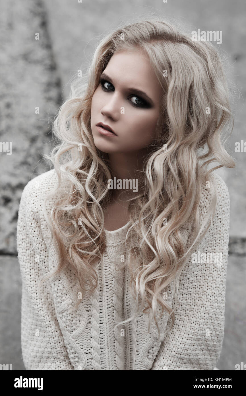 Close Up Of Beautiful Young Blonde Woman With Blue Eyes In White