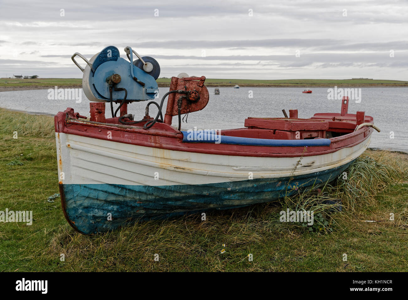 Traditional flat bottomed fishing boat or coble beached at the inner