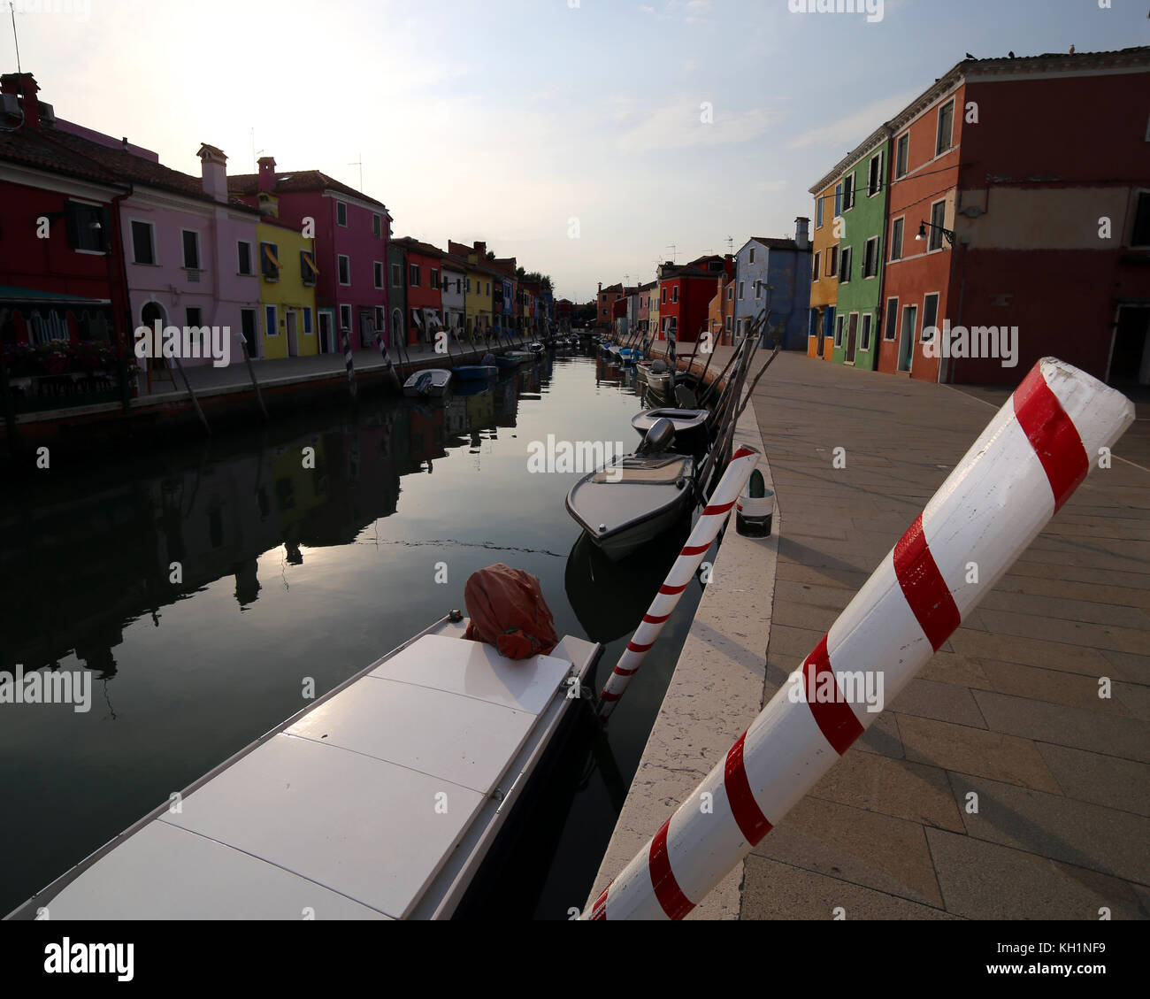 Boats moored in the navigable canal of Burano island near Venice Stock Photo