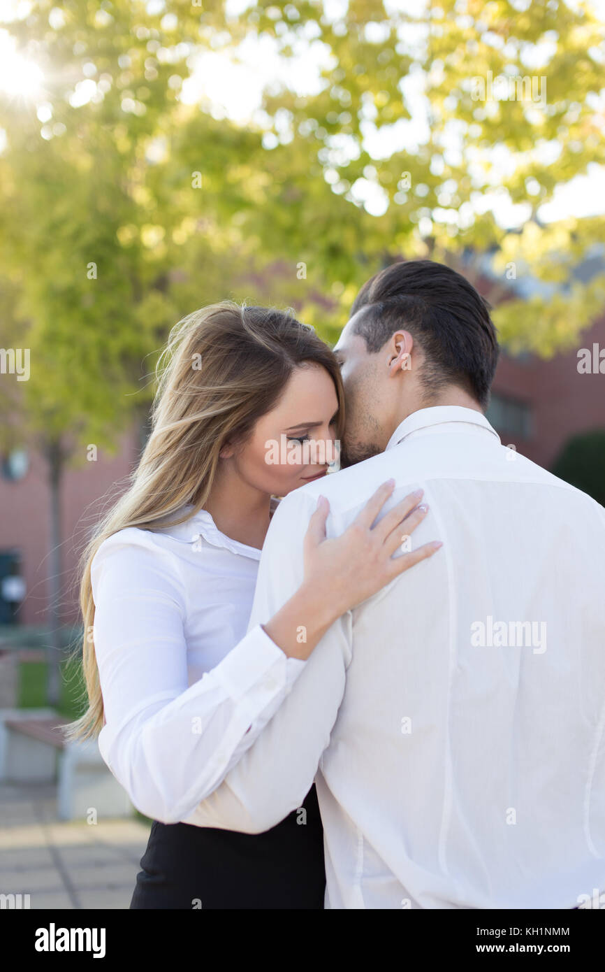 Young caucasian woman embracing boyfriend, love in business between managers Stock Photo
