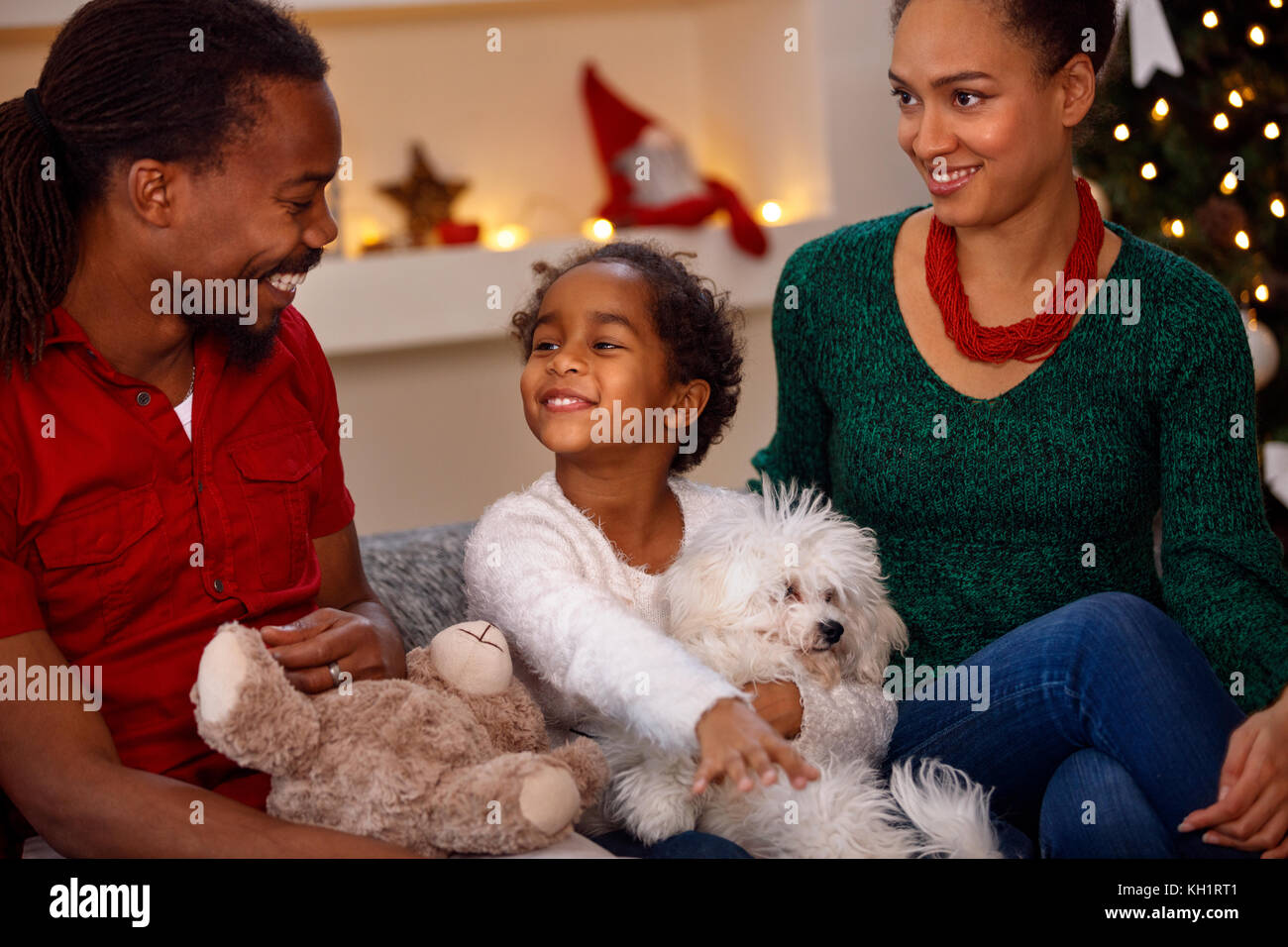 Young smiling Black family with presents at Christmas Stock Photo - Alamy