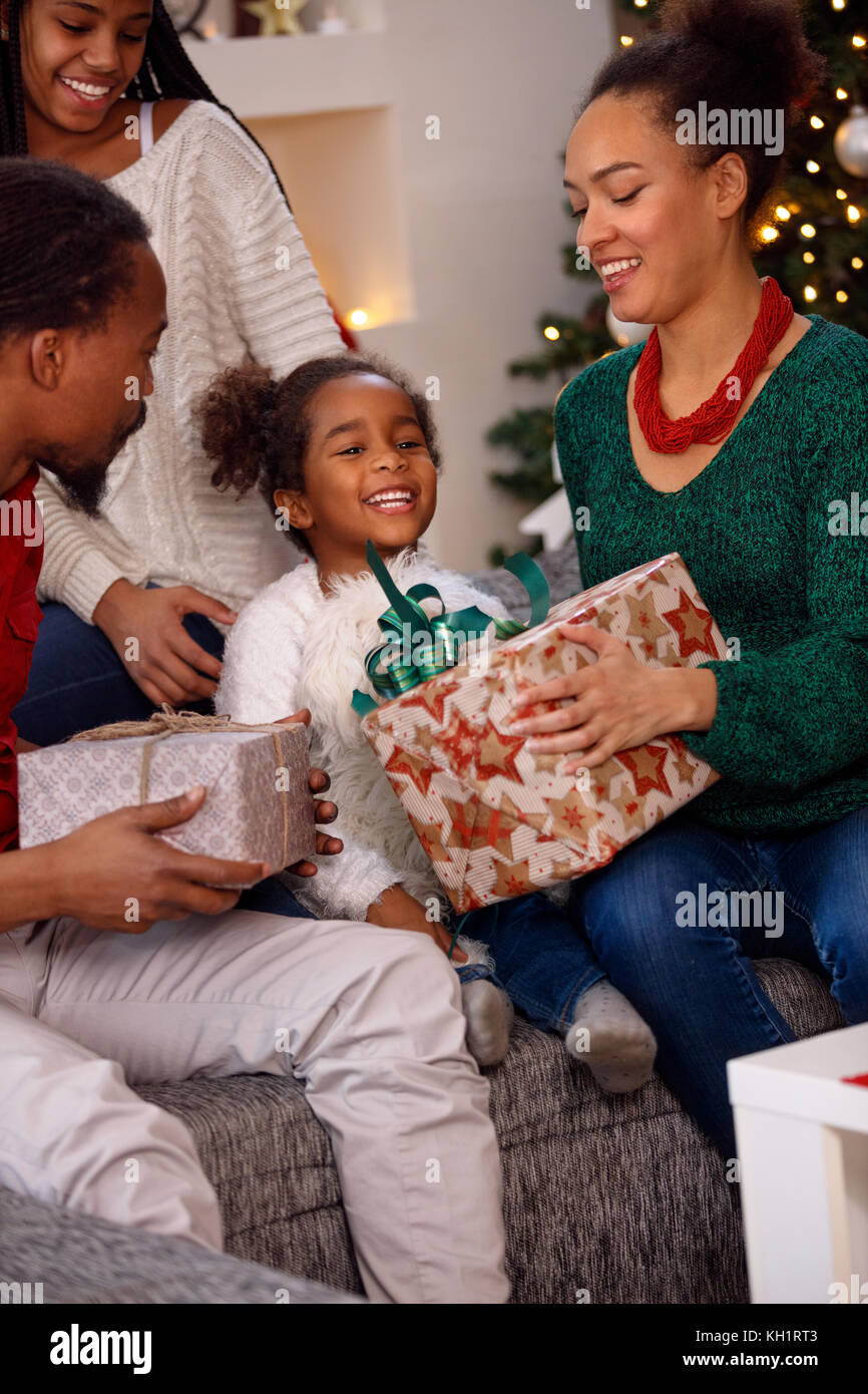 Happy afro American family opening present on Christmas Stock Photo