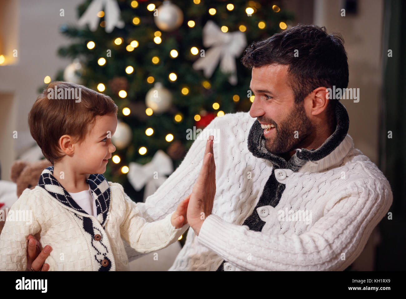 smiling father and son have fun for Christmas Stock Photo - Alamy