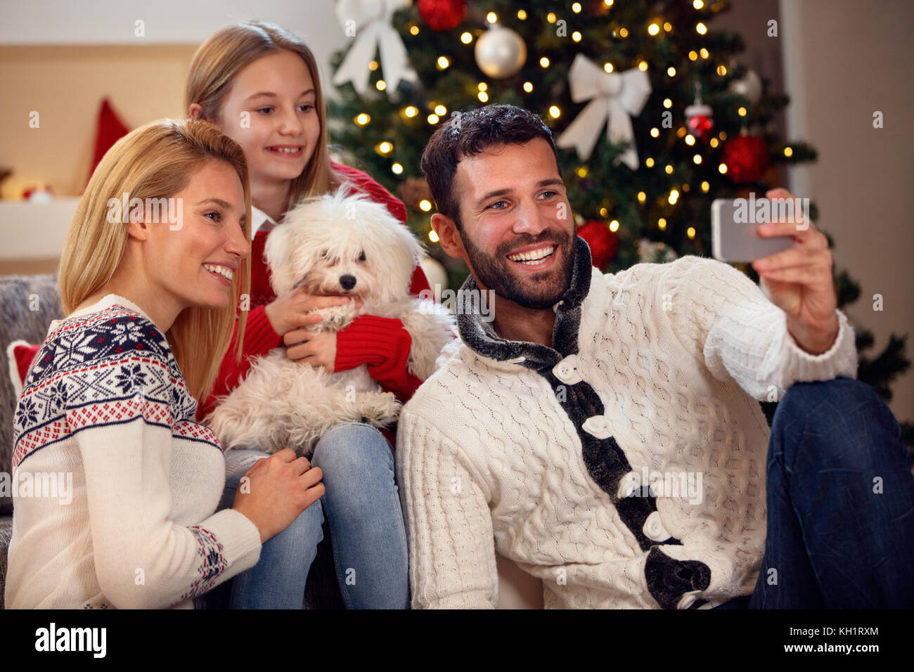 Christmas time family self-portrait- young smiling family Stock Photo