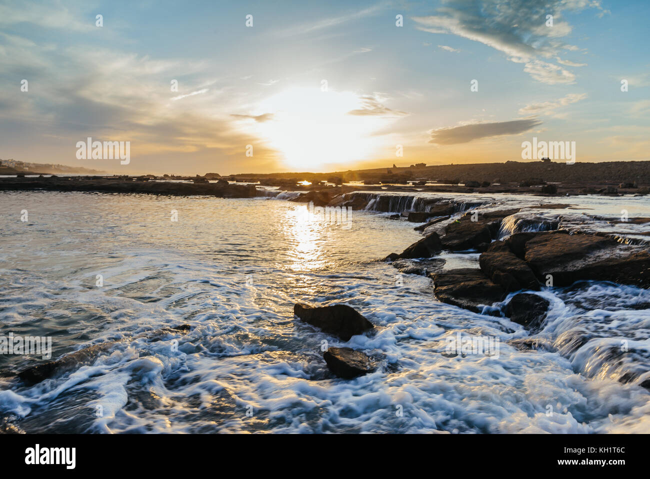 Beautiful sunset at harhoura, rabat, from inside the waters, view of the rocks and the sea Stock Photo