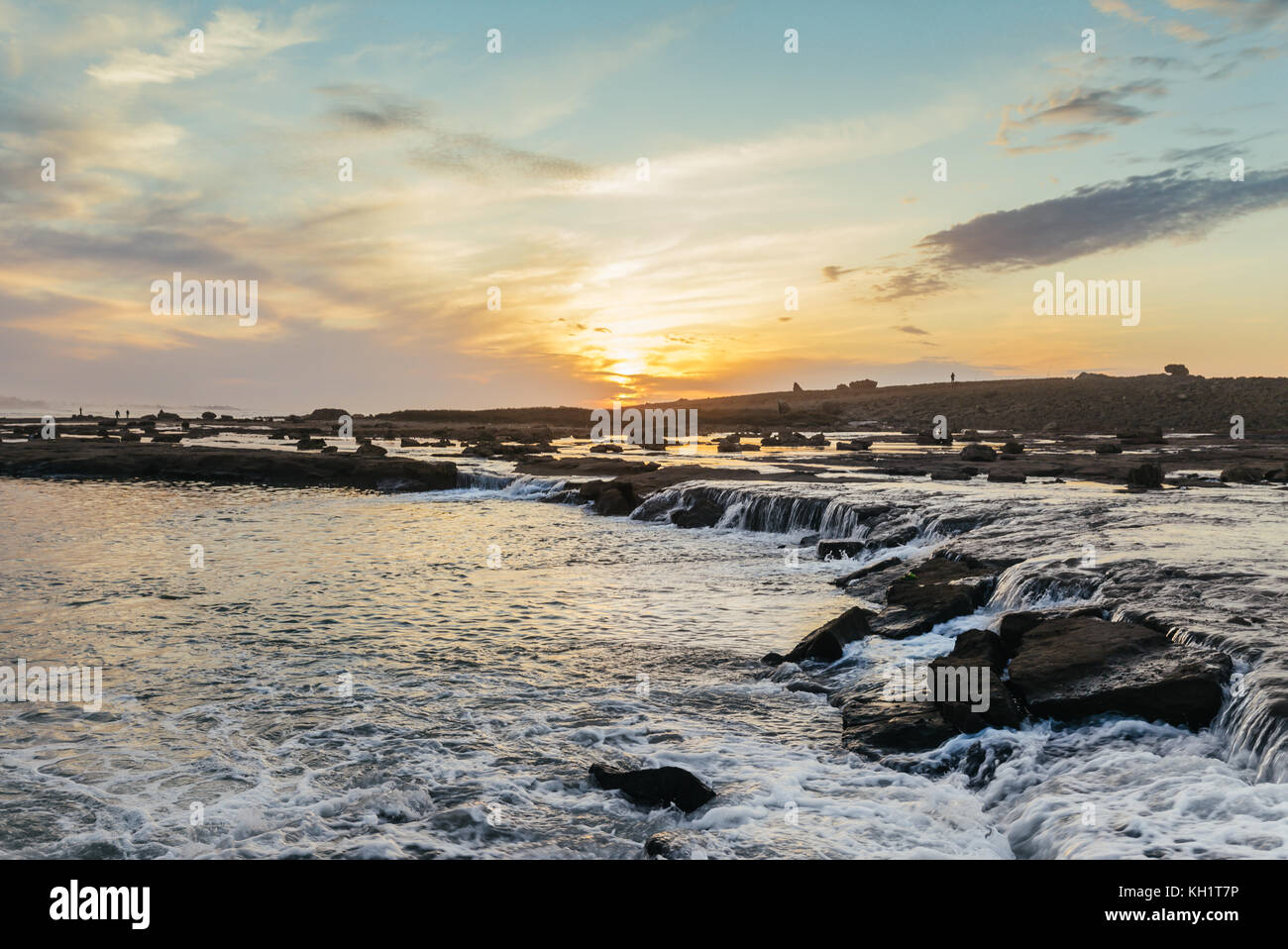 Mini waterfalls in Harhoura, Rabat, Morocco at sunset. View of the rocks and the sea from inside the waters Stock Photo