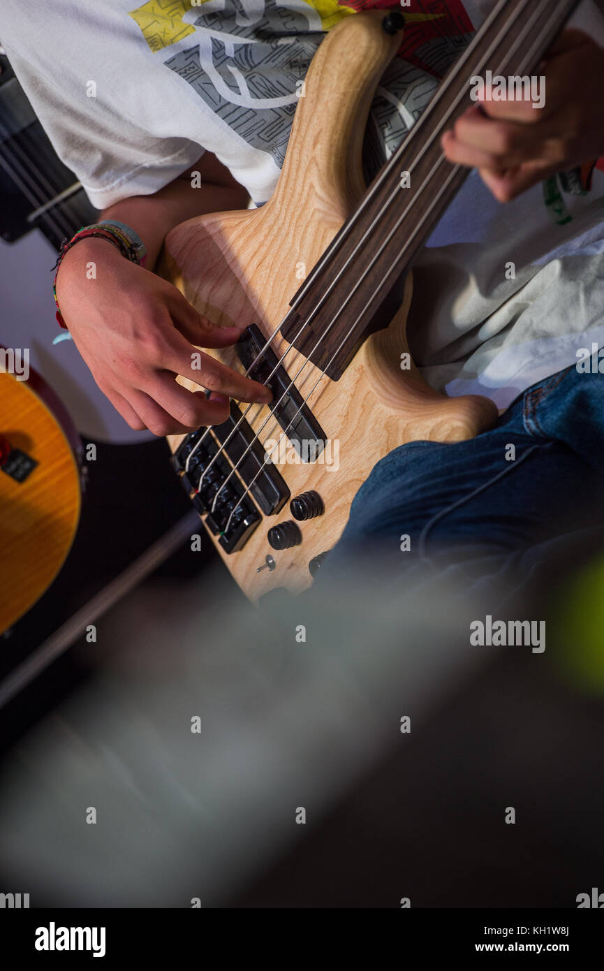 Musician playing a bass guitar in shop, france Stock Photo Alamy