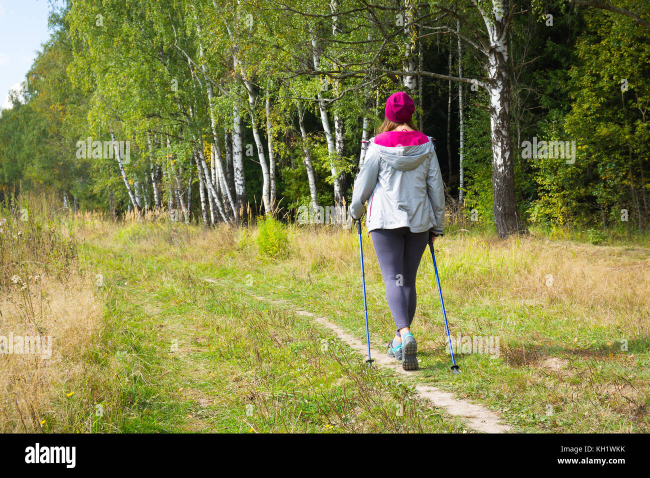 Young woman goes Nordic walking Stock Photo