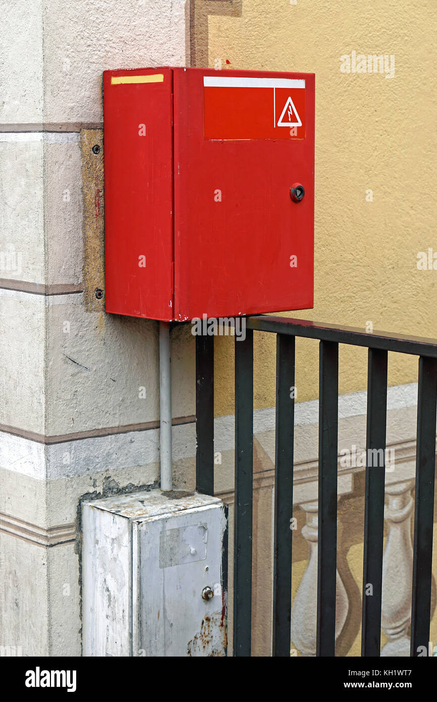 Red box with electric cut off safety switch at house wall Stock Photo