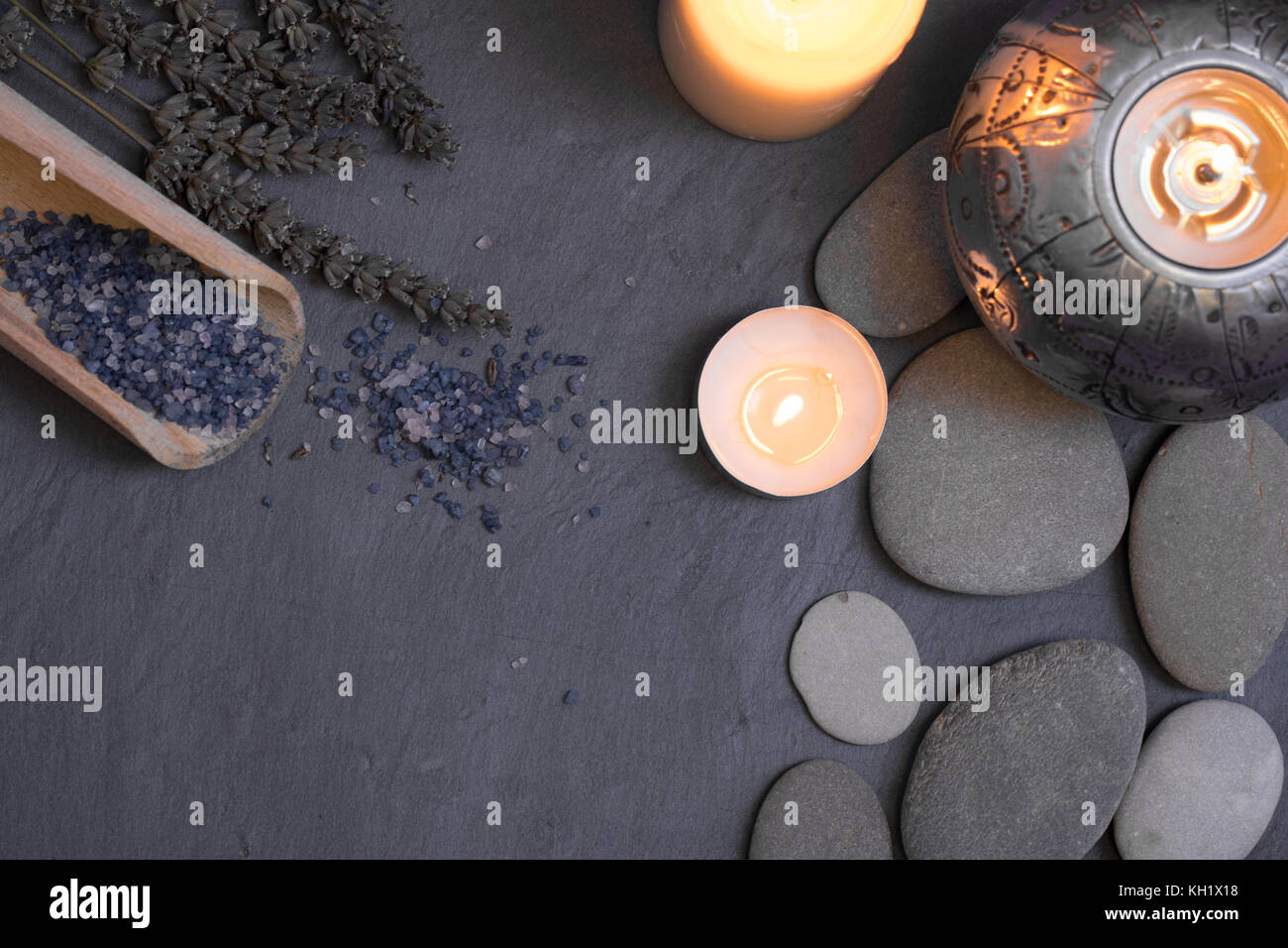 spa and wellness still life composition with candles and pebble stones Stock Photo