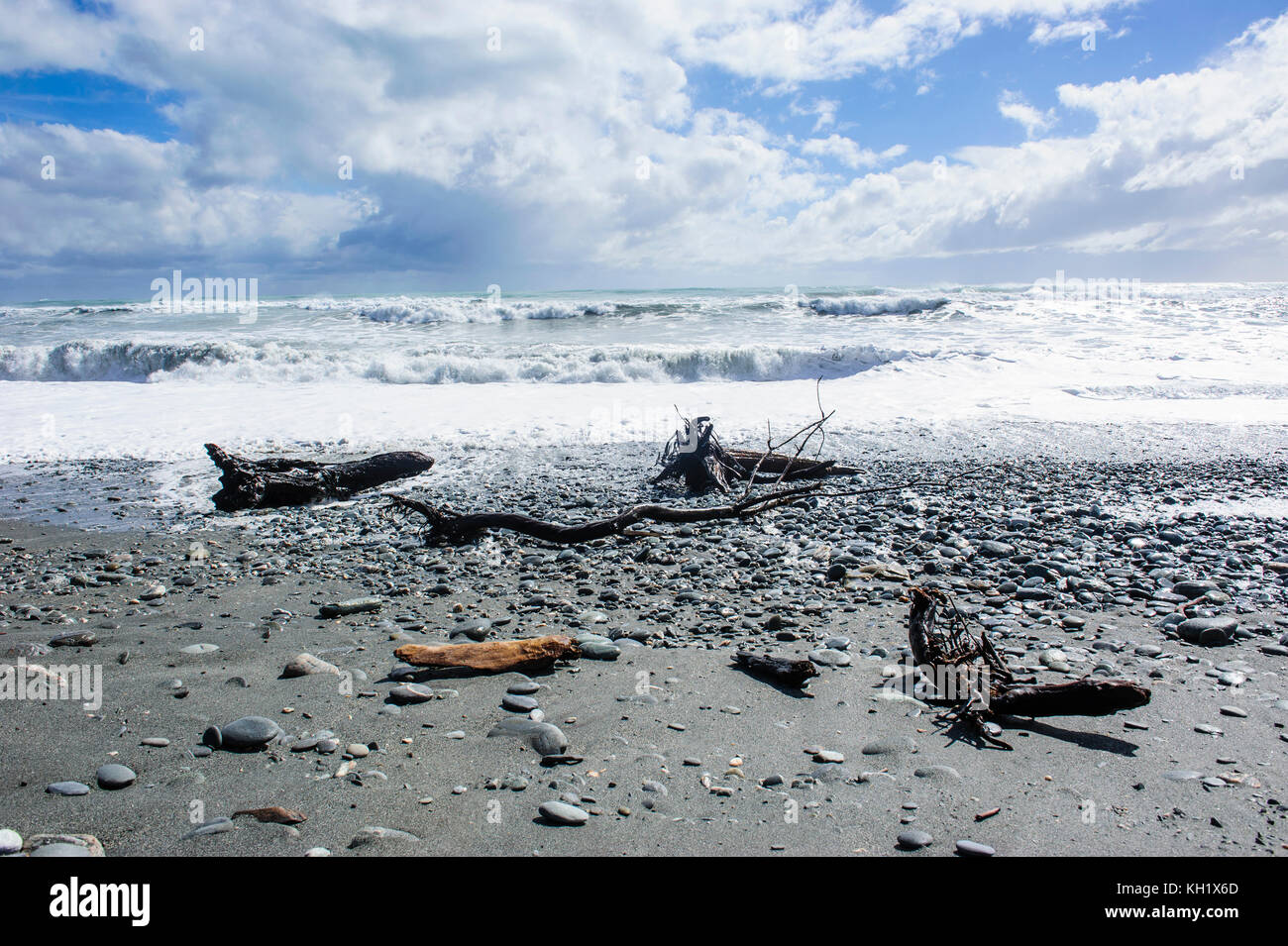 Grey rocky beach in Okarito along the road between Fox Glacier and ...