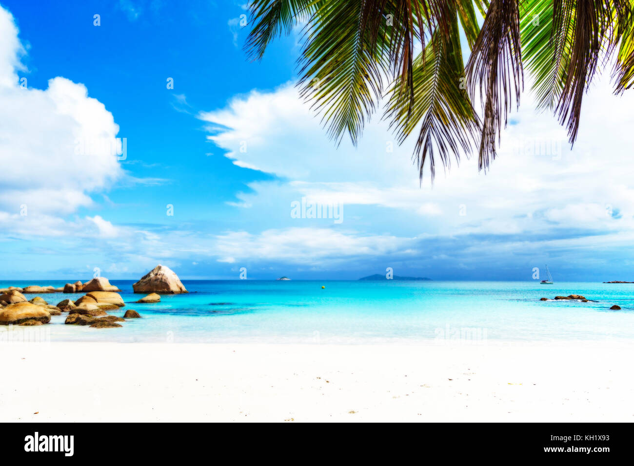 Picturesque dream beach with white sand, golden granite rocks, palm trees, turquoise water and a blue sky at anse lazio on praslin island on the seych Stock Photo