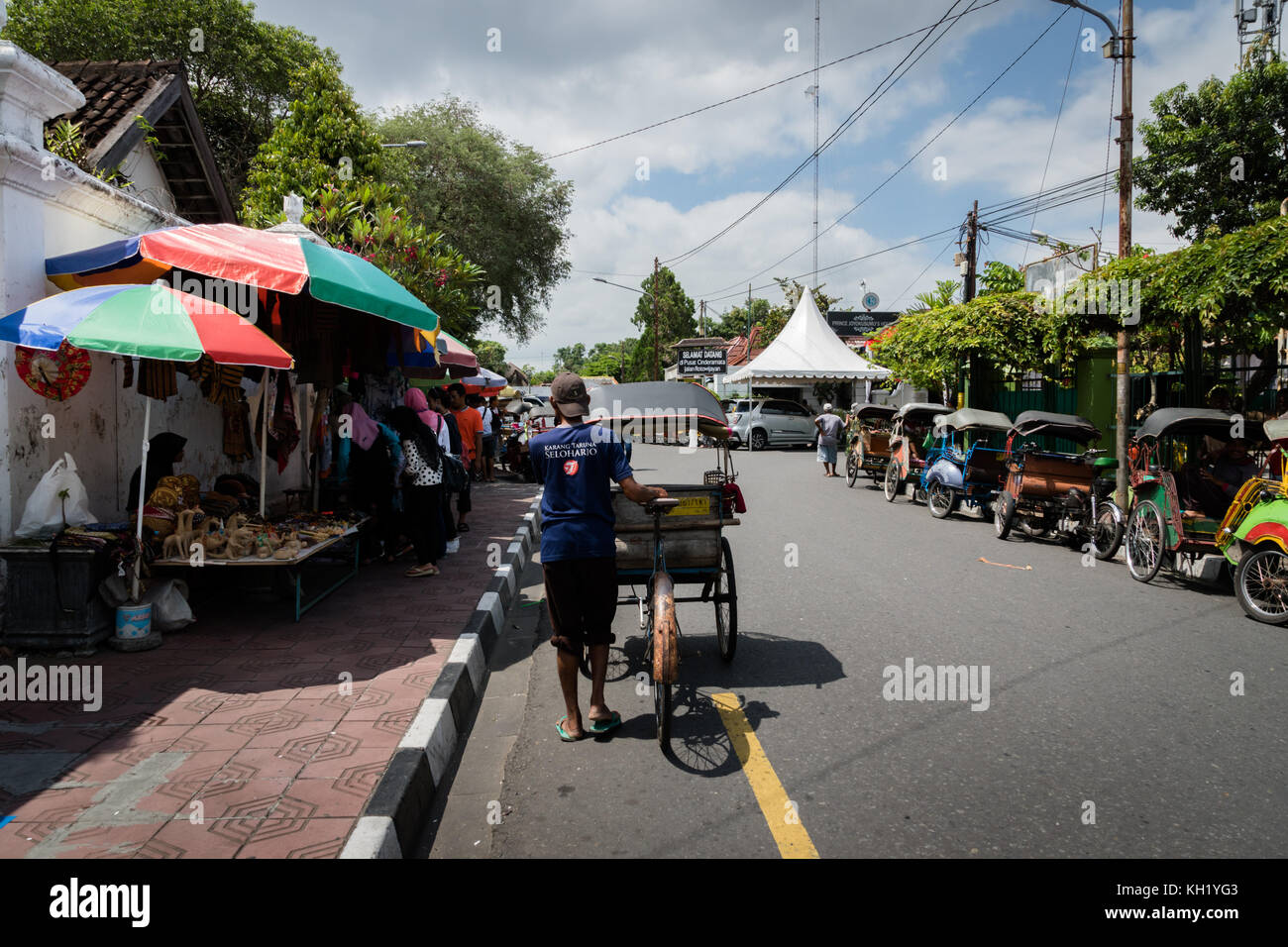 Yogyakarta - October 2017: Traditional rikshaw transport on streets of Yogyakarta, Java, Indonesia. Bicycle rikshaw remains popular means of transport Stock Photo