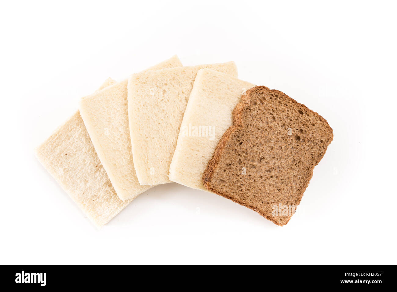 White no crust sandwich bread slices with one of them wholesome brown, on white background. Stock Photo