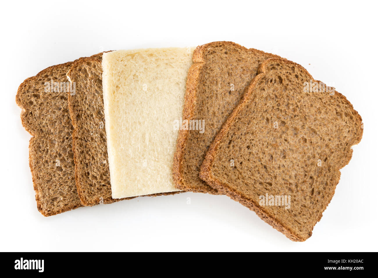 Whole grain sandwich bread slices with one white slice, on white