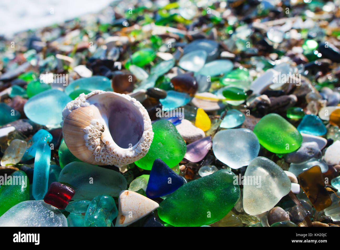 Beach fully covered with multicolored glass pebble. Wonder of nature