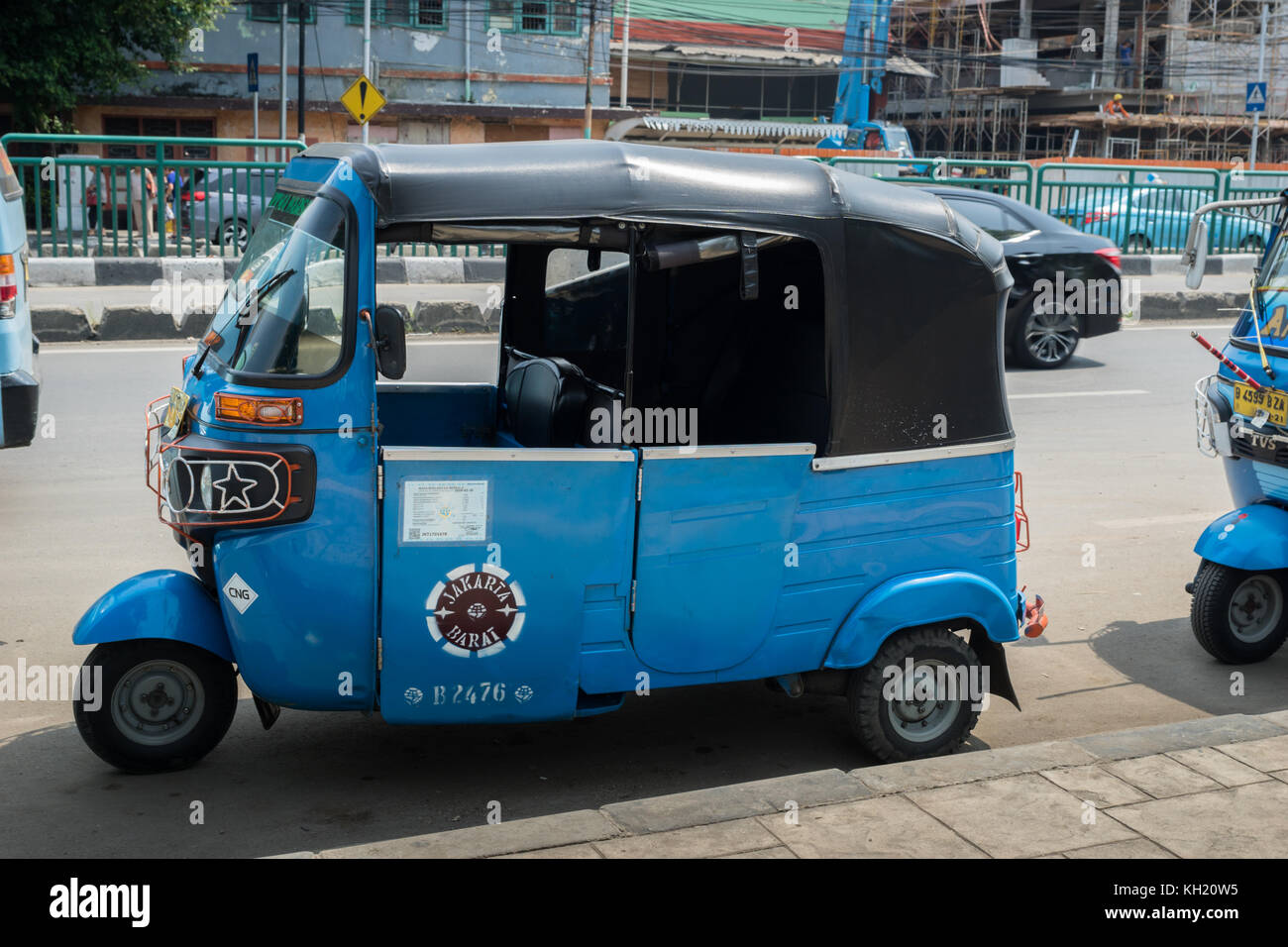 Jakarta, Indonesia - November 2017: Tuk Tuk, motorized rickshaw, in downtown Jakarta. Rickshaw is a common form of public transport in South East Asia Stock Photo