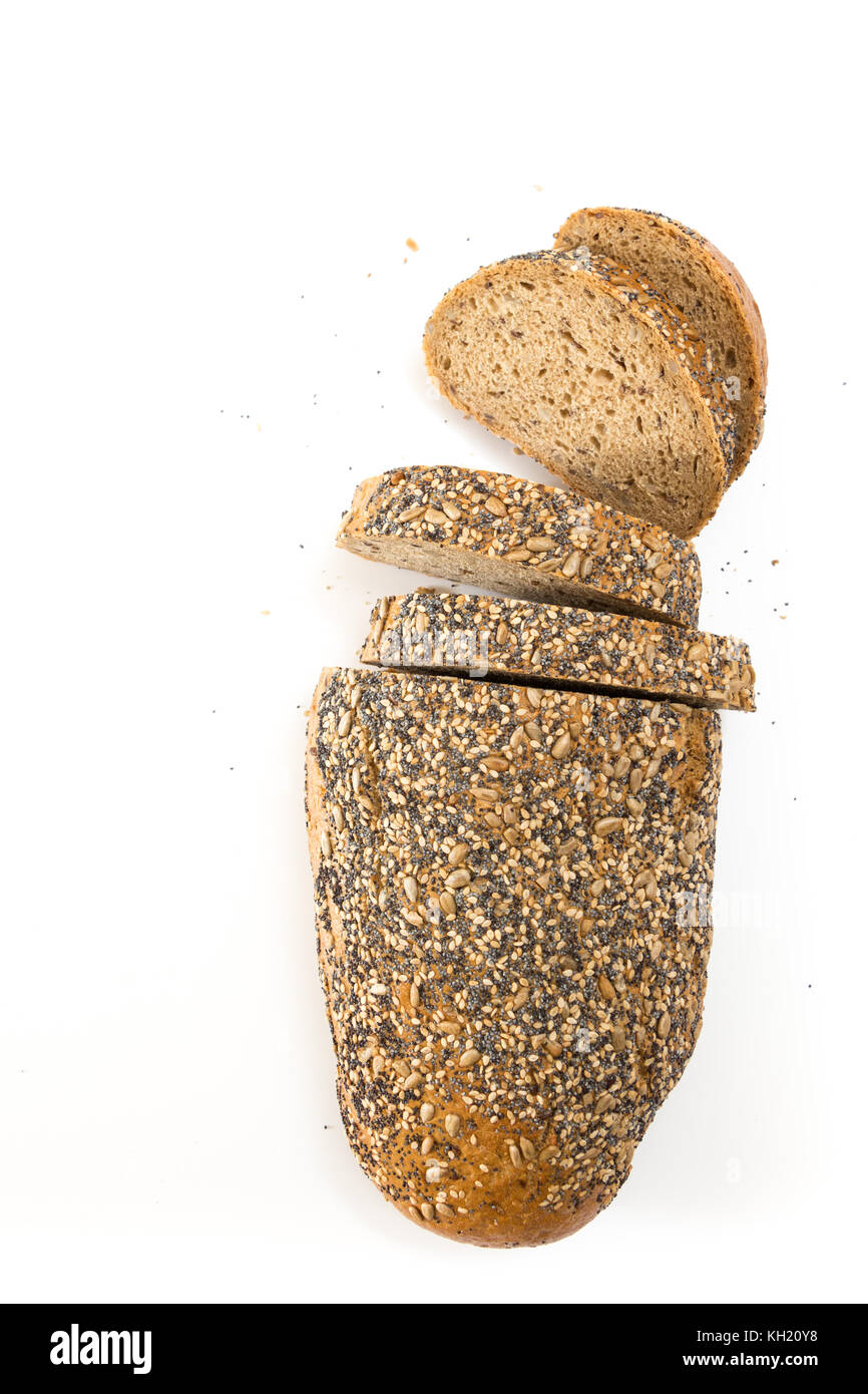 Whole wheat bread with seeds sliced, on white background. Stock Photo