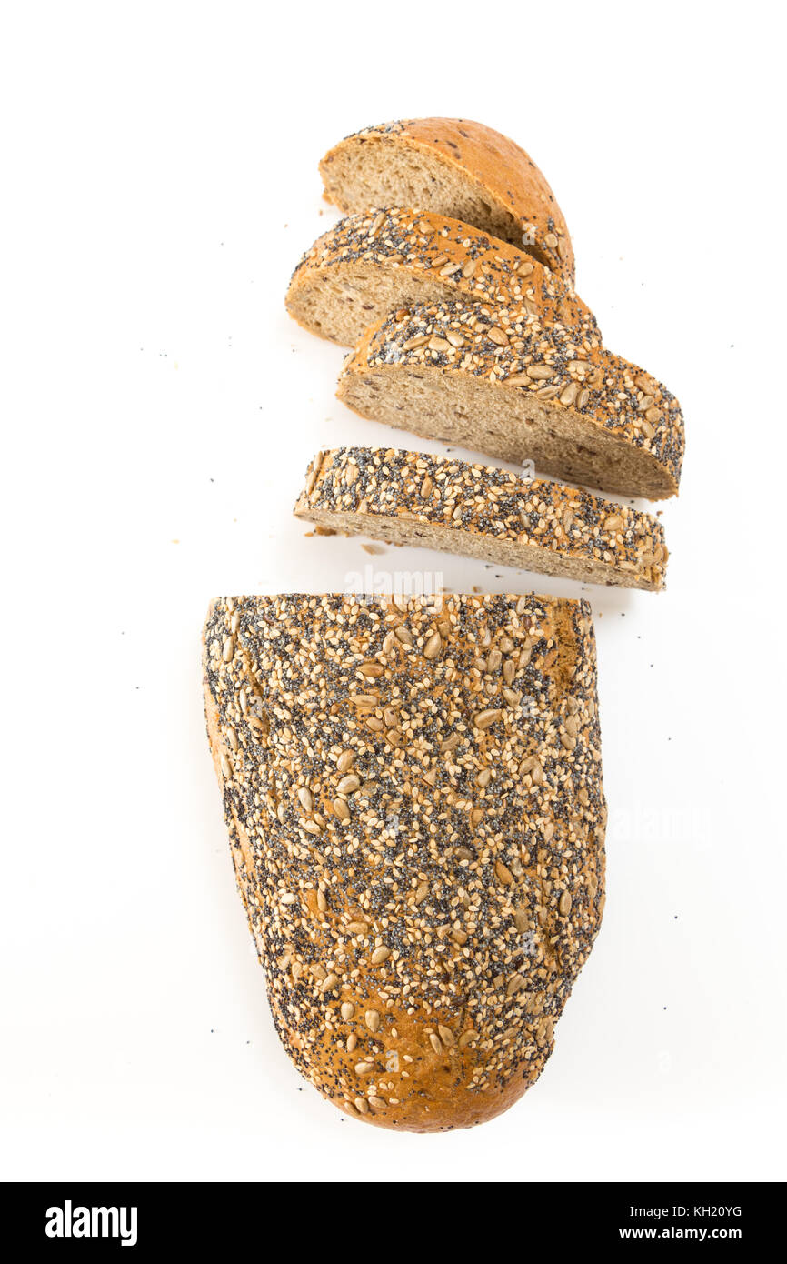 Whole wheat bread with seeds sliced, on white background. Stock Photo