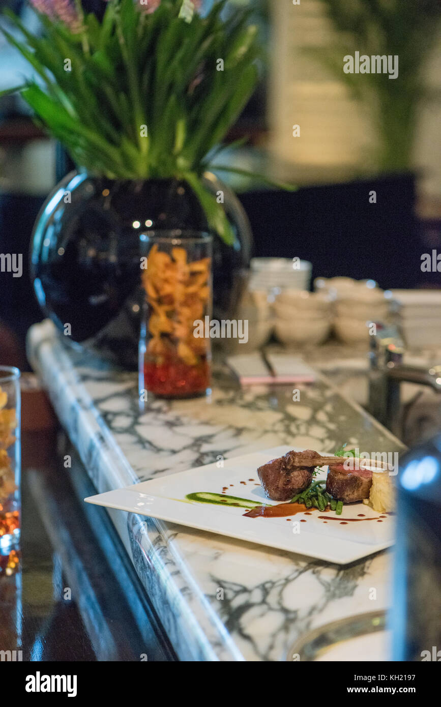 A lamb shank dish on a marble bar top. Stock Photo