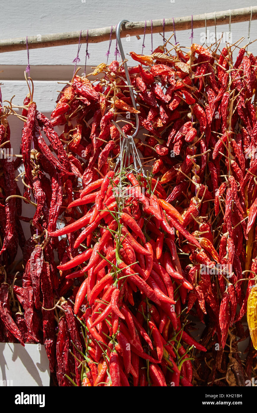 Bunch of red Neapolitan pepper weigh on the market in Italy Stock Photo