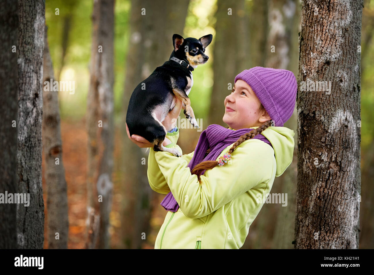 baby girl outdoors with a small dog.smiling teenage girl relaxing with dog.Cute  teen girl wearing a jacket and purple hat, walking with her Chihuahua Stock  Photo - Alamy